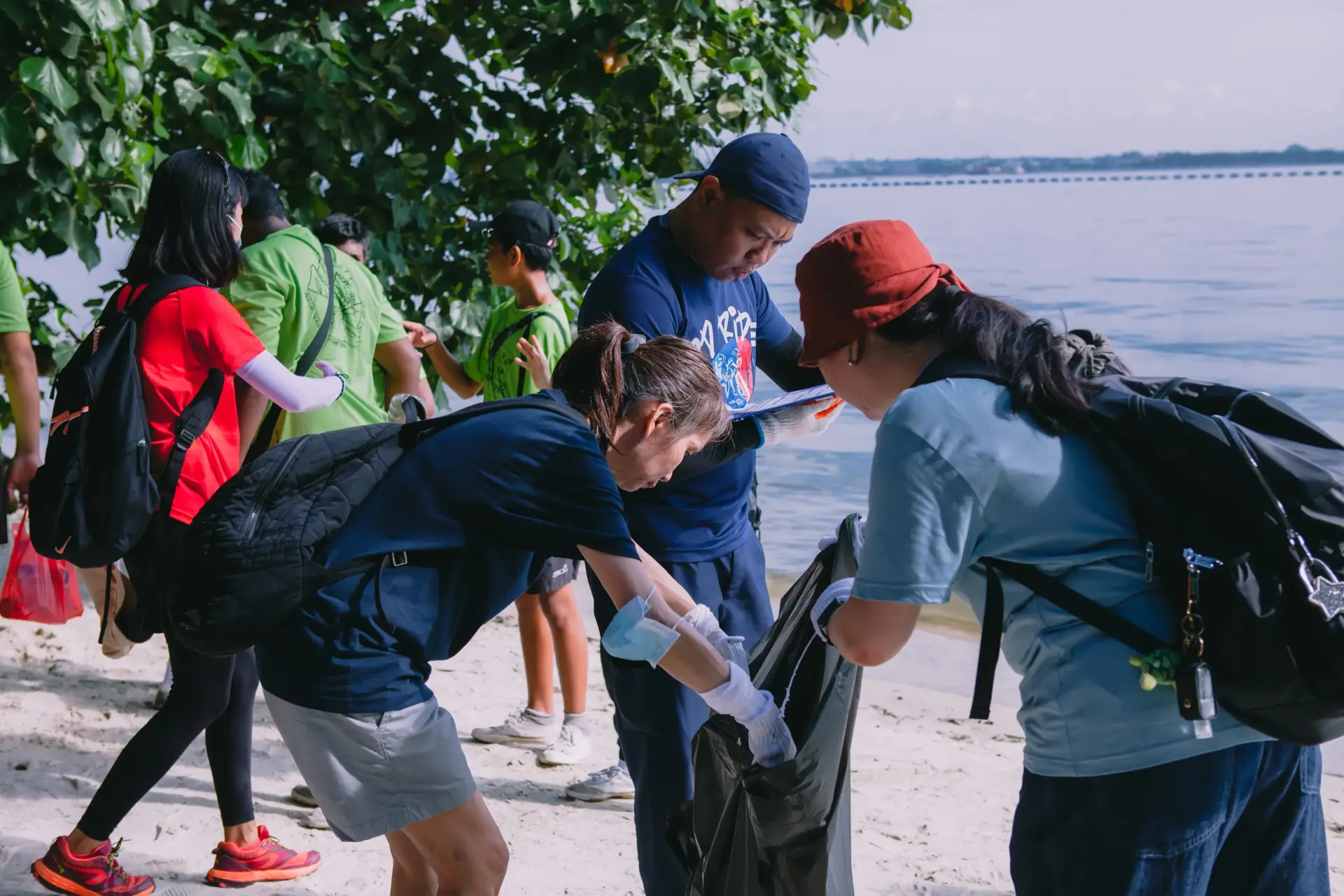 A group of volunteers cleaning up a beach