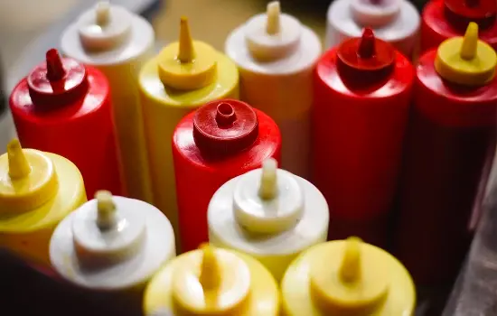 Red, yellow, and white condiment squeeze bottles