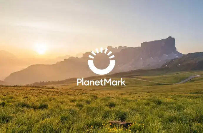Landscape sunset with white Planet Mark logo overlay