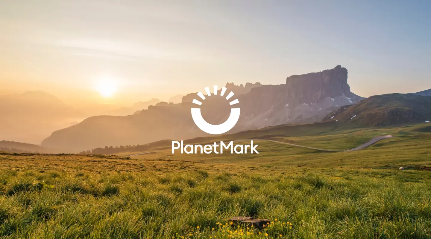 Landscape sunset with white Planet Mark logo overlay
