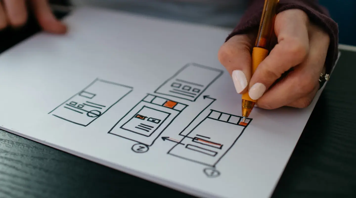 Hand creating a drawing of a wireframe