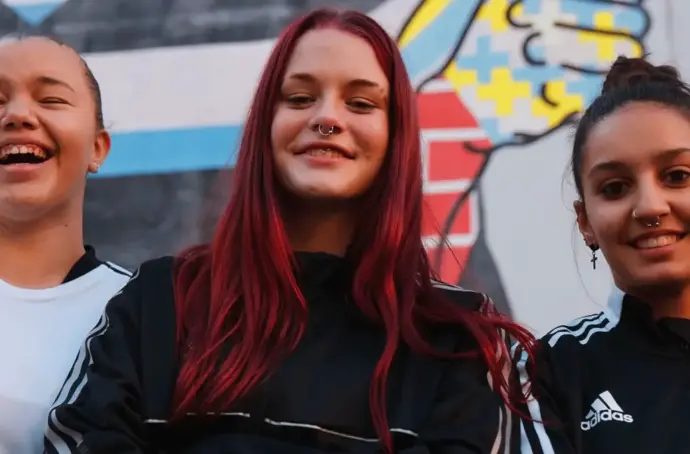 three sporty kids smiling