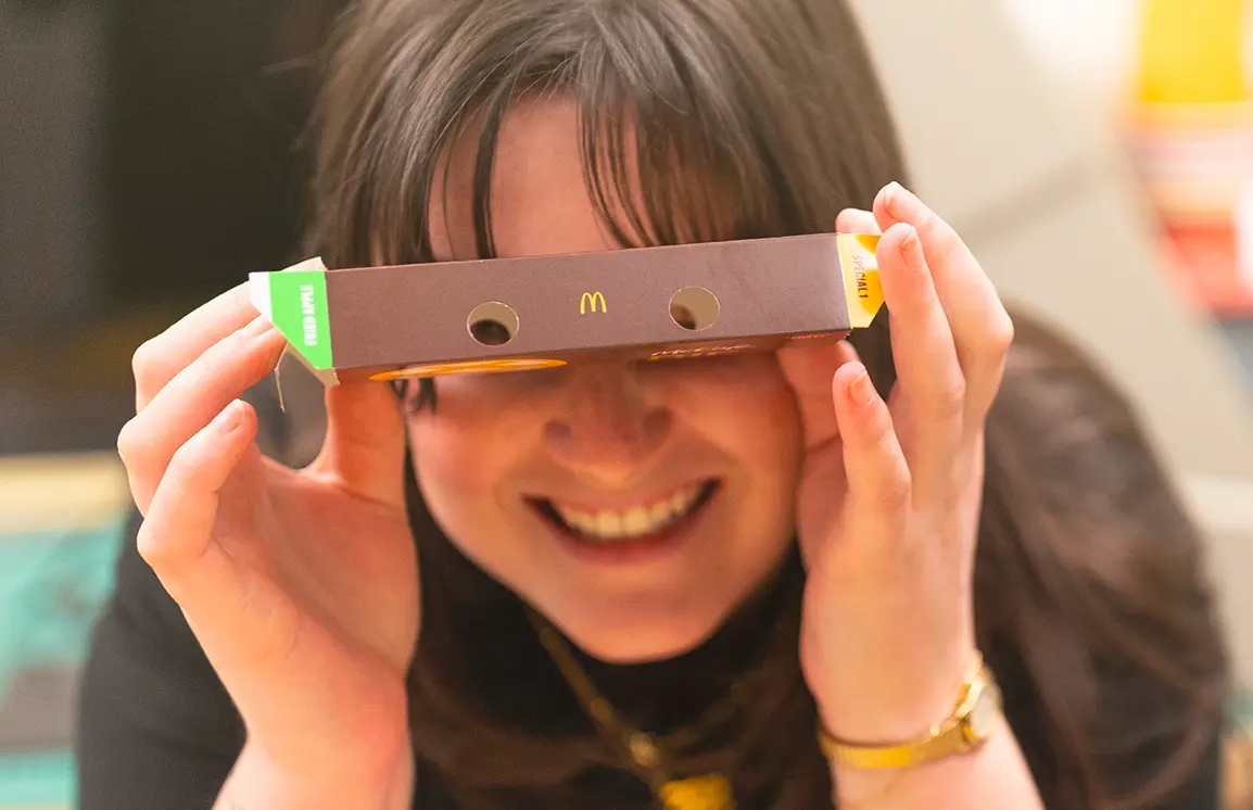 girl looking through a McCafe cardboard box