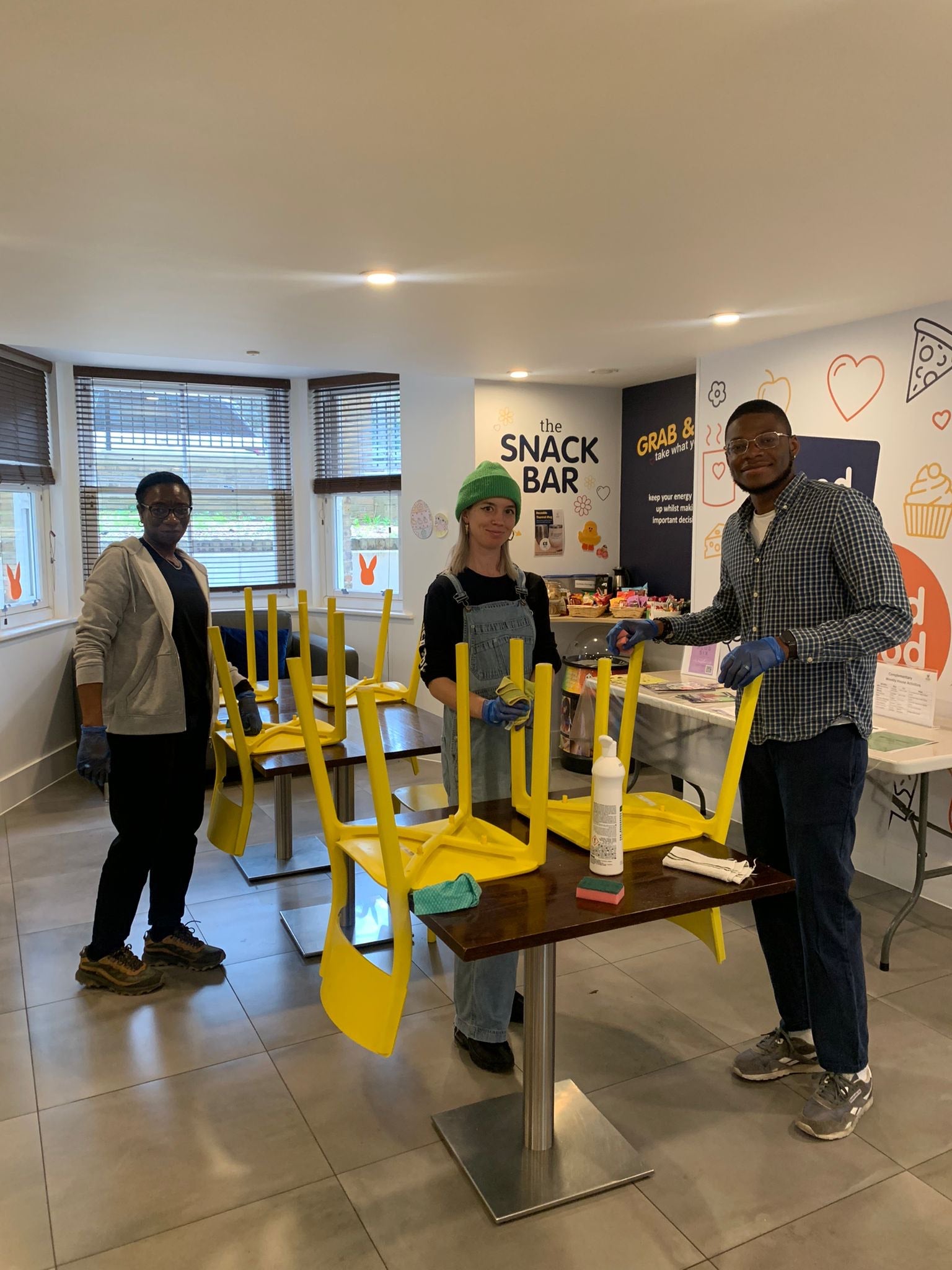 Image of people putting chairs on desk