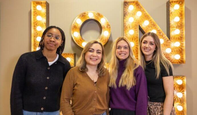 A photo of tms London's new digital team with four members posing for a photo