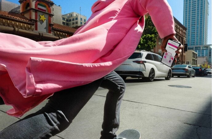 man in pink coat on skateboard