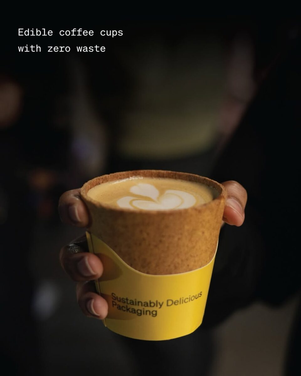 someone holding a sustainable edible coffee cup with descriptive text top left of image