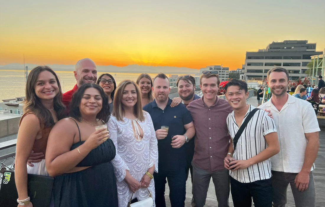 People taking a picture infront of a sunset