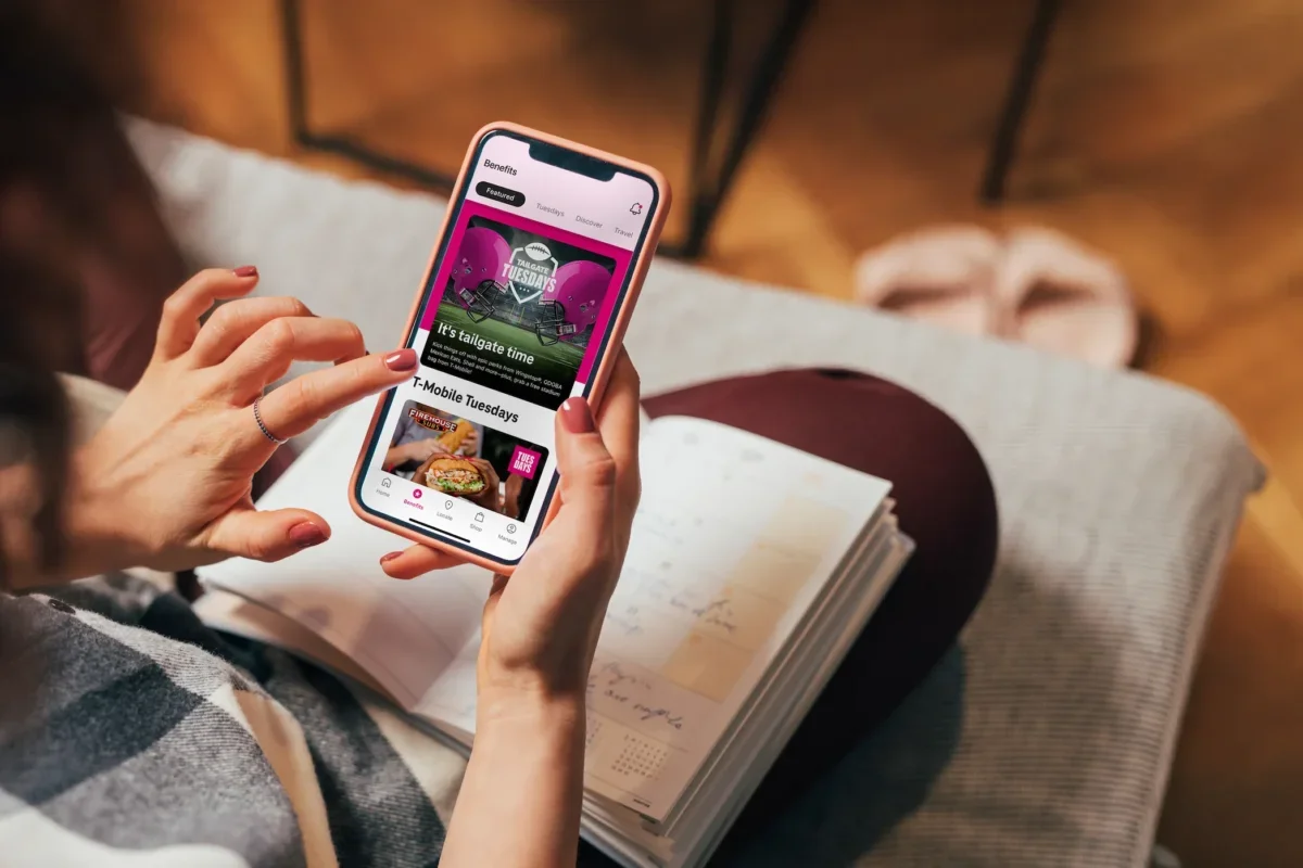 over the shoulder view of a lady using the tmobile app in a relaxed environment