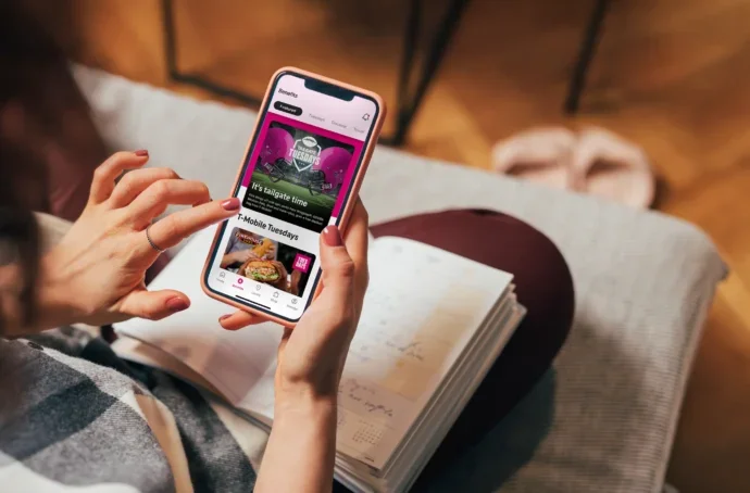 over the shoulder view of a lady using the tmobile app in a relaxed environment
