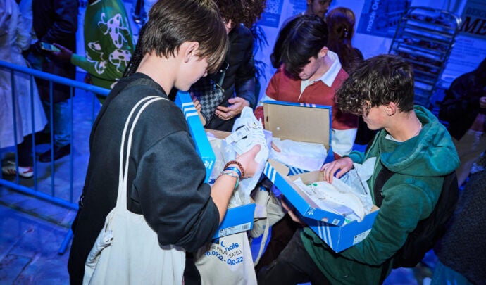 People unboxing adidas shoes